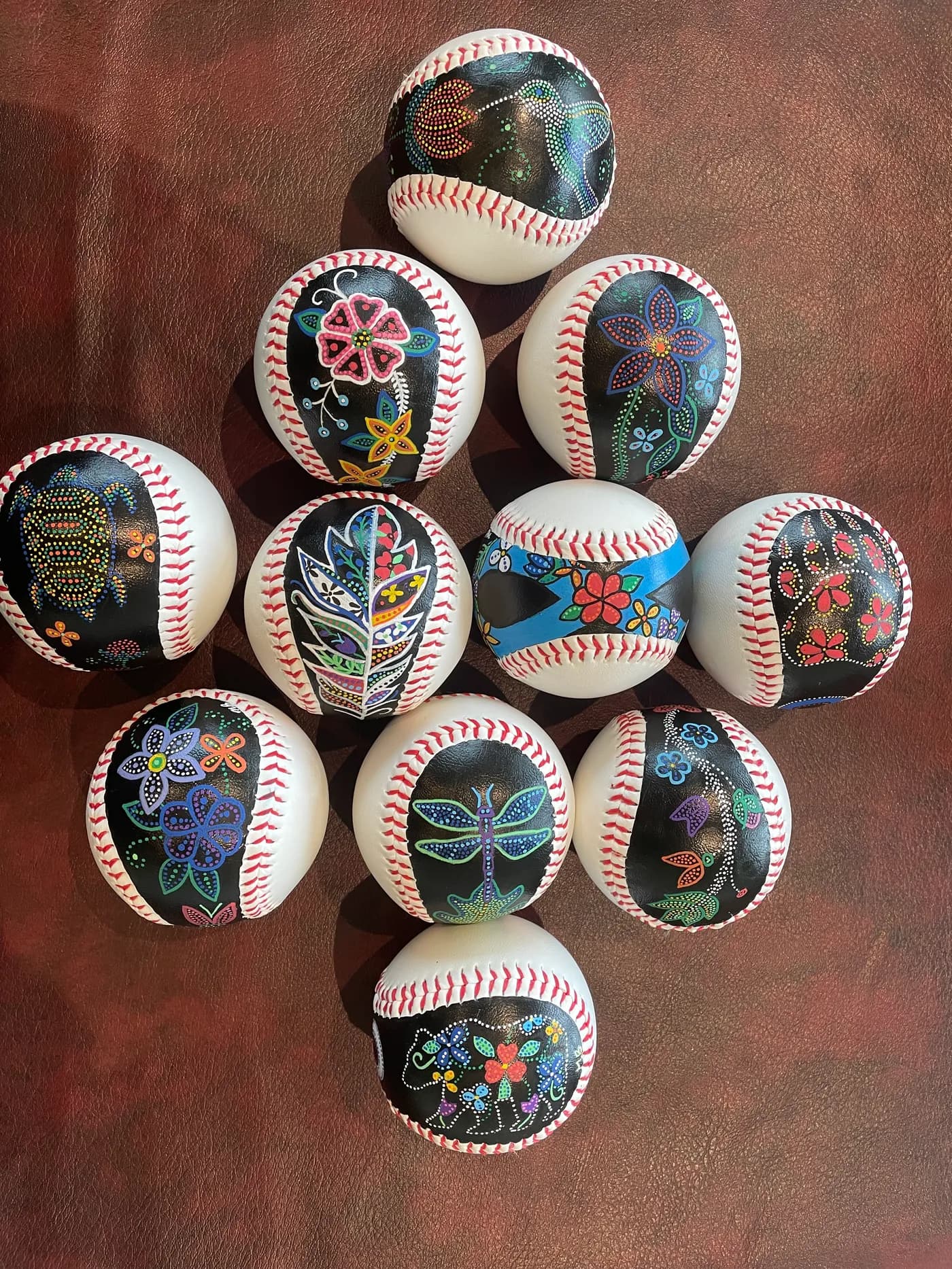 Hand-painted baseballs with Métis floral dot designs