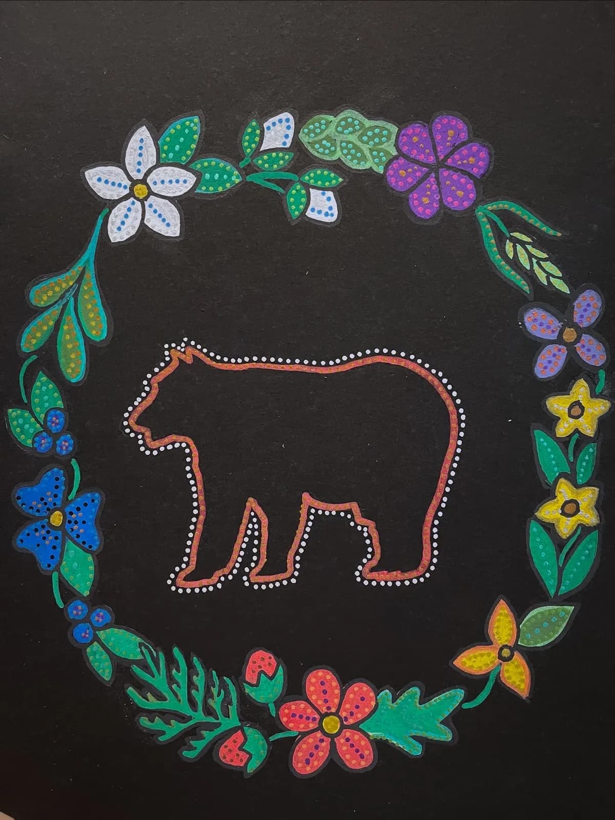 Bear outlined in dots inside a wreath of flowers