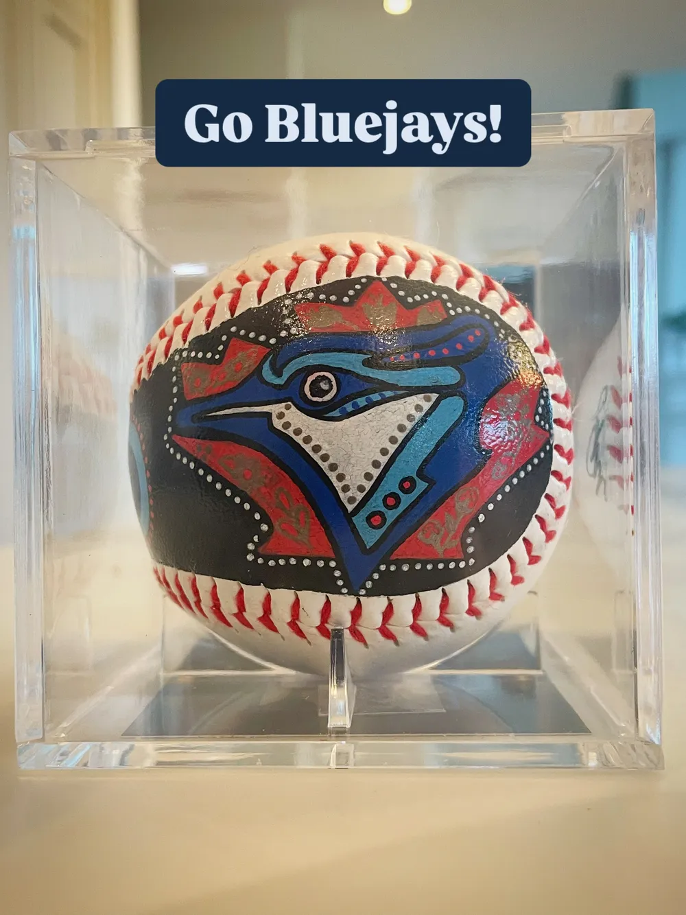 Custom hand-painted Toronto Blue Jays baseball in a display case