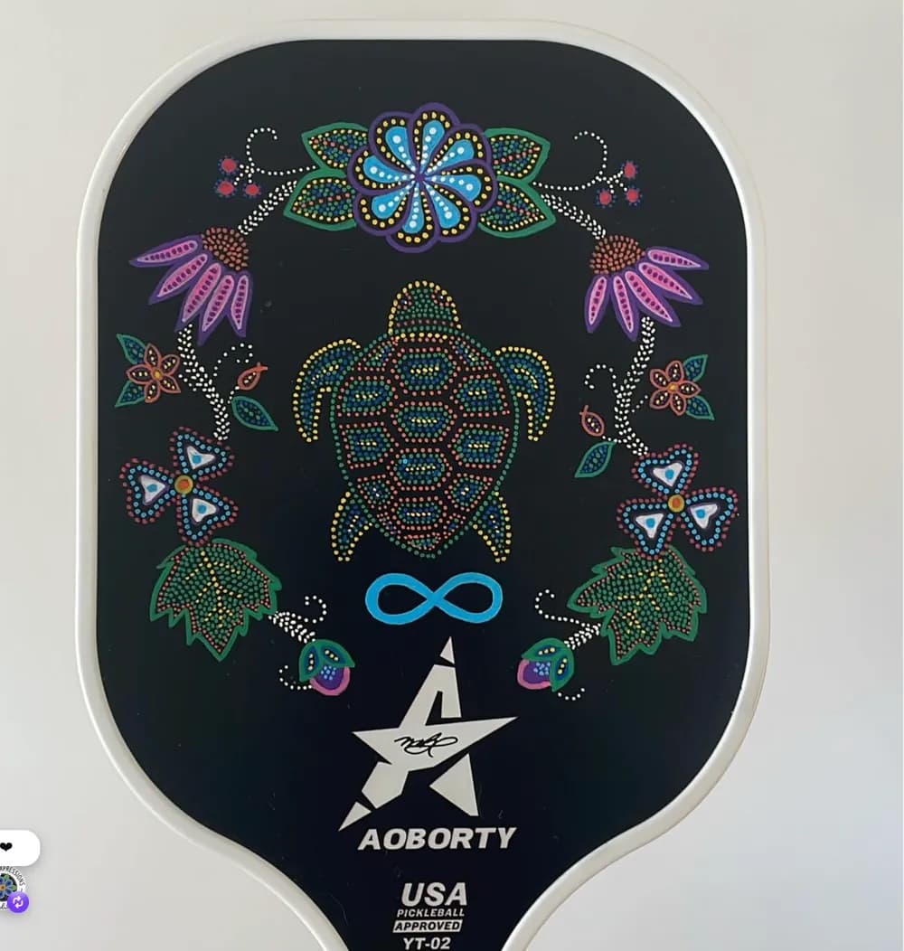 Pickleball paddle painted with a turtle and flowers
