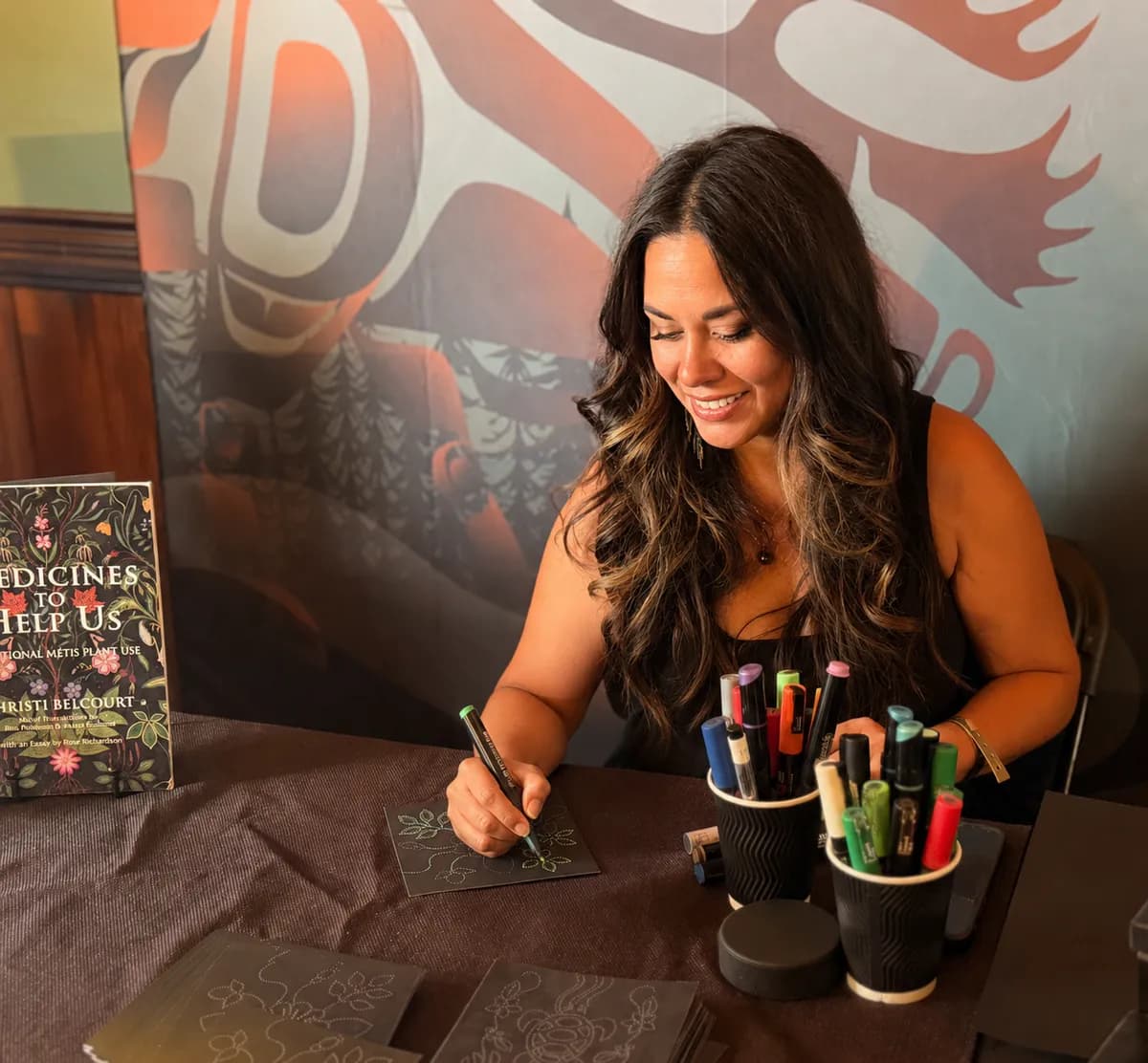 Michelle working on a dot painting at an event